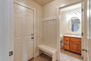 Interior space with light tile patterned flooring and sink