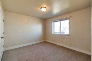 Spare room featuring light colored carpet