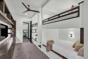 Bedroom featuring ceiling fan and dark colored carpet