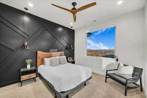 Carpeted bedroom with ceiling fan