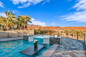 View of swimming pool with a mountain view, a patio, and an outdoor fire pit