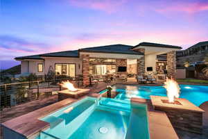 View of swimming pool featuring a patio area, a fireplace, and an outdoor fire pit