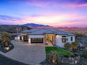 Prairie-style home featuring a garage and a mountain view