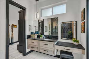 Bathroom featuring vanity and tile patterned floors