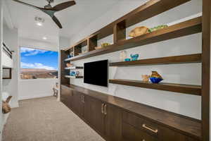 Interior space featuring built in desk and ceiling fan