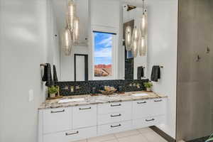 Bathroom with vanity, tile patterned flooring, and decorative backsplash