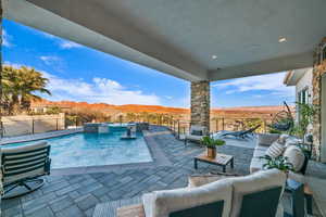 View of pool with pool water feature, an outdoor living space, a mountain view, and a patio