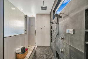 Bathroom with tile walls and a tile shower