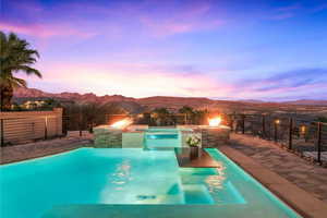 Pool at dusk with a mountain view