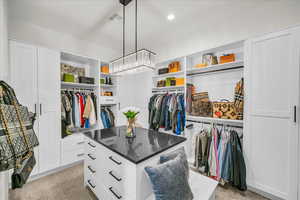 Spacious closet with light carpet