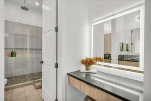 Bathroom featuring vanity, tile patterned floors, toilet, and walk in shower