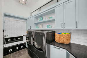 Laundry area featuring cabinets and washing machine and dryer