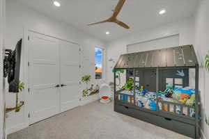 Bedroom featuring ceiling fan, carpet flooring, and a closet