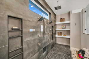 Bathroom featuring tiled shower