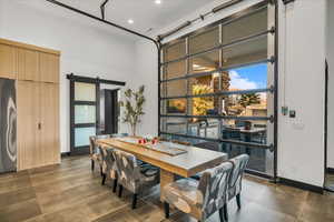 Dining space featuring a barn door and a high ceiling