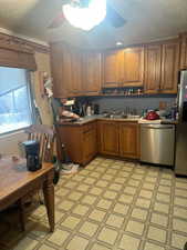 Kitchen featuring sink, stainless steel appliances, and ceiling fan