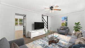 Living room with ceiling fan, ornamental molding, and a textured ceiling