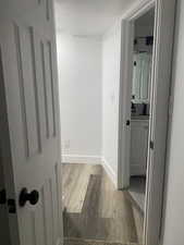 Corridor featuring wood-type flooring and a textured ceiling