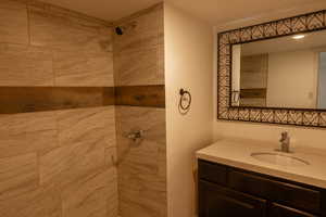 Bathroom with vanity and a tile shower