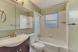 Full bathroom featuring vanity, toilet, and shower / bath combination