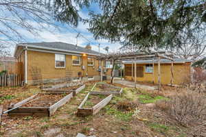 Rear view of house featuring central AC unit and a pergola