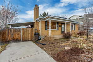 Bungalow-style home with a carport and a porch