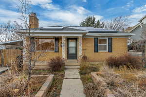 Bungalow with solar panels and covered porch