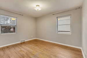 Unfurnished room with light hardwood / wood-style floors