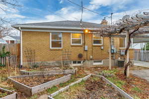 Rear view of house featuring central AC