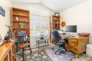 Office area with lofted ceiling