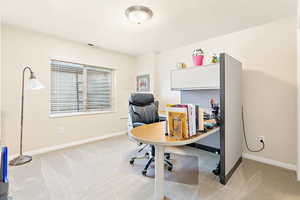 Basement Office with light colored carpet