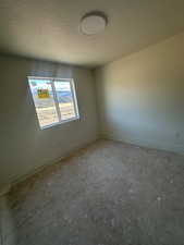 Bedroom 3 featuring a textured ceiling