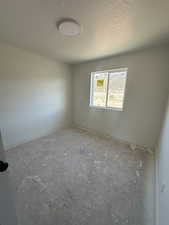 Bedroom 2 with a textured ceiling