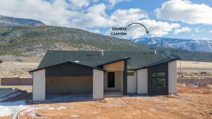 View of front of home featuring a mountain view and a patio area