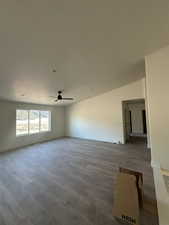 Spare room featuring a textured ceiling, wood-type flooring, and ceiling fan