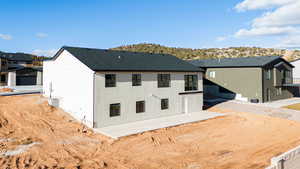 Rear view of house featuring a patio