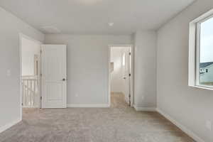 PHOTOS FROM SIMILAR HOME. COLORS & SELECTIONS WILL VARY. Bedroom 2 featuring light colored carpet