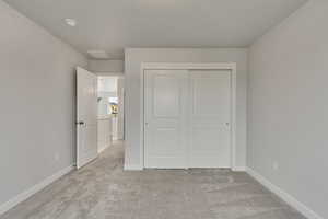 PHOTOS FROM SIMILAR HOME. COLORS & SELECTIONS WILL VARY. Bedroom 4 with a closet and light carpet