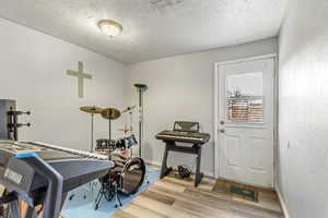 Interior space featuring hardwood / wood-style flooring and a textured ceiling