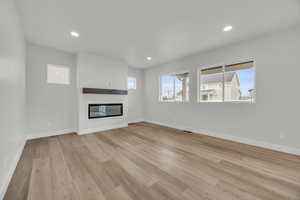 Unfurnished living room featuring light wood-type flooring