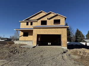 Unfinished property featuring a garage