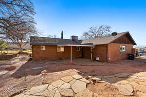 Back of house with a patio area and central air condition unit