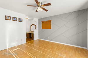 Empty room featuring ceiling fan and wood-type flooring