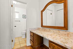 Bathroom with vanity, tile patterned flooring, and toilet