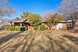 Single story home featuring a front lawn