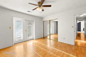 Unfurnished bedroom with french doors, ceiling fan, access to outside, and hardwood / wood-style flooring