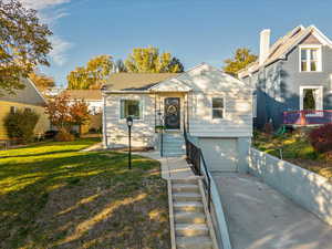 View of front facade with a garage and a front lawn