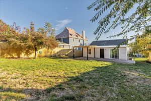 Rear view of property featuring a patio area and a lawn