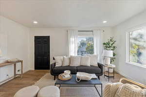 Living room featuring light hardwood / wood-style floors and a textured ceiling