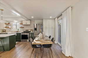 Dining room with sink and light hardwood / wood-style flooring